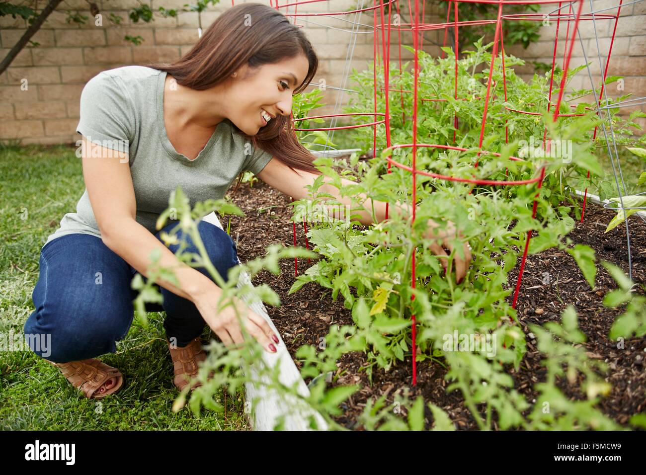 Woman working in garden bed Stock Photo