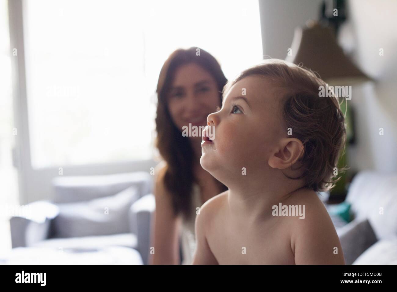 Head and shoulder side view of baby boy looking up Stock Photo Alamy