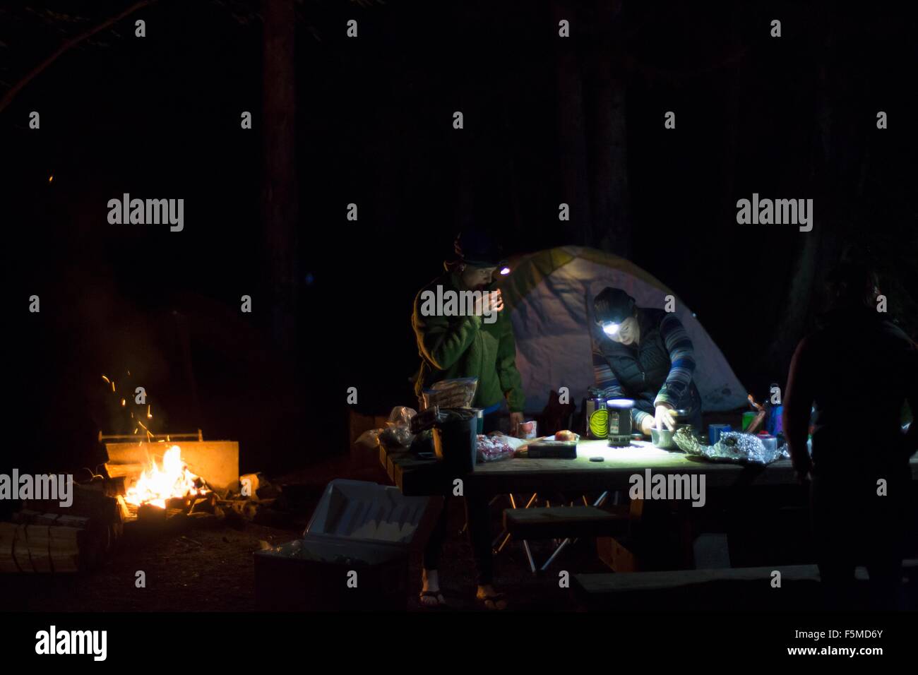 Hikers preparing dinner at camp Stock Photo