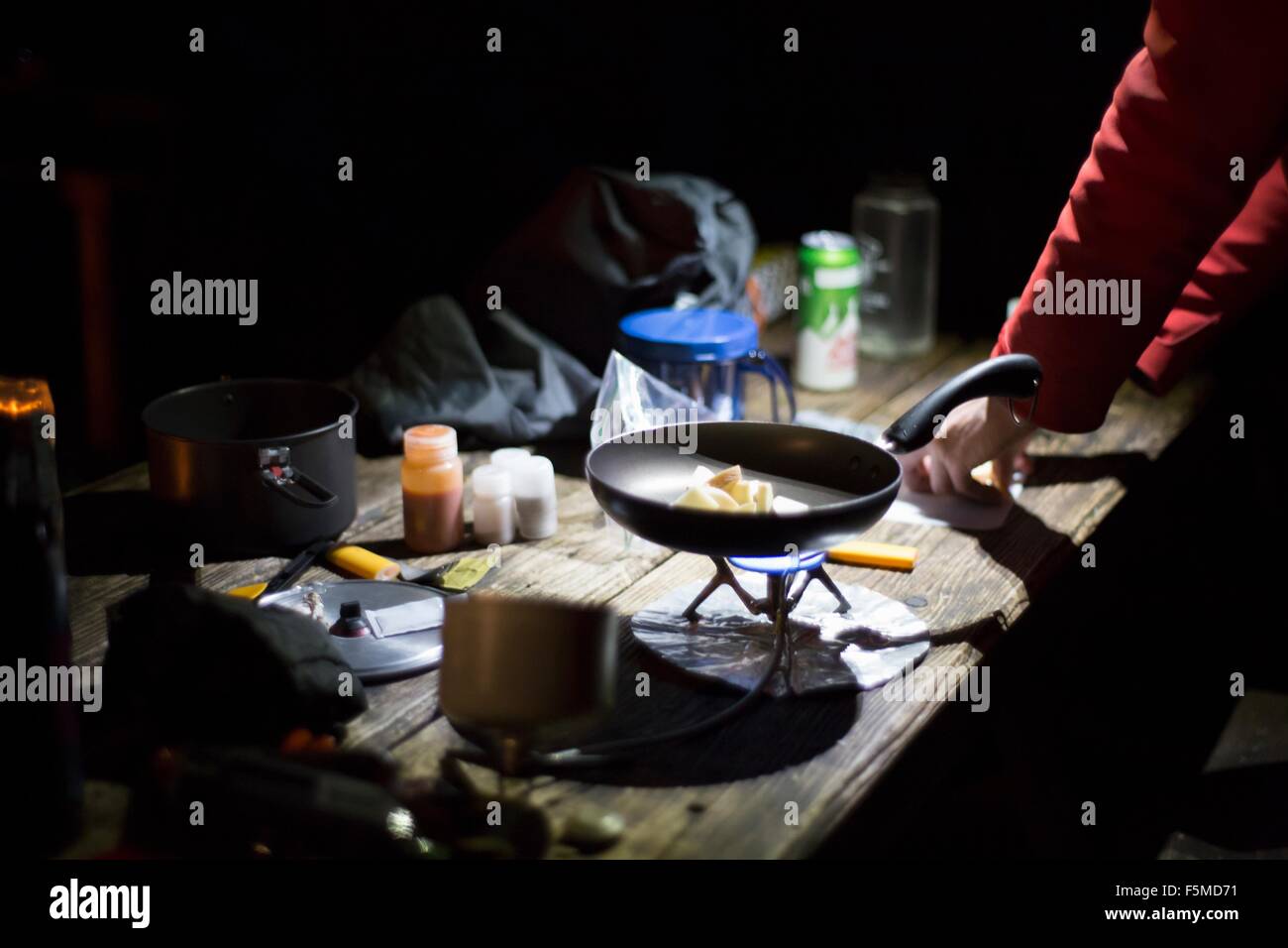 Hiker preparing dinner at camp Stock Photo