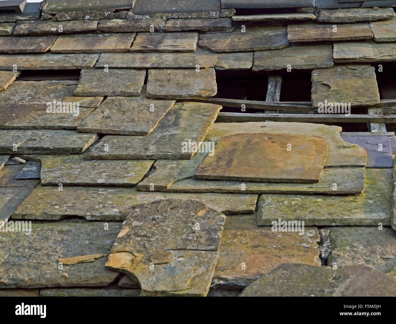 Stone tile roof in need of repair Stock Photo