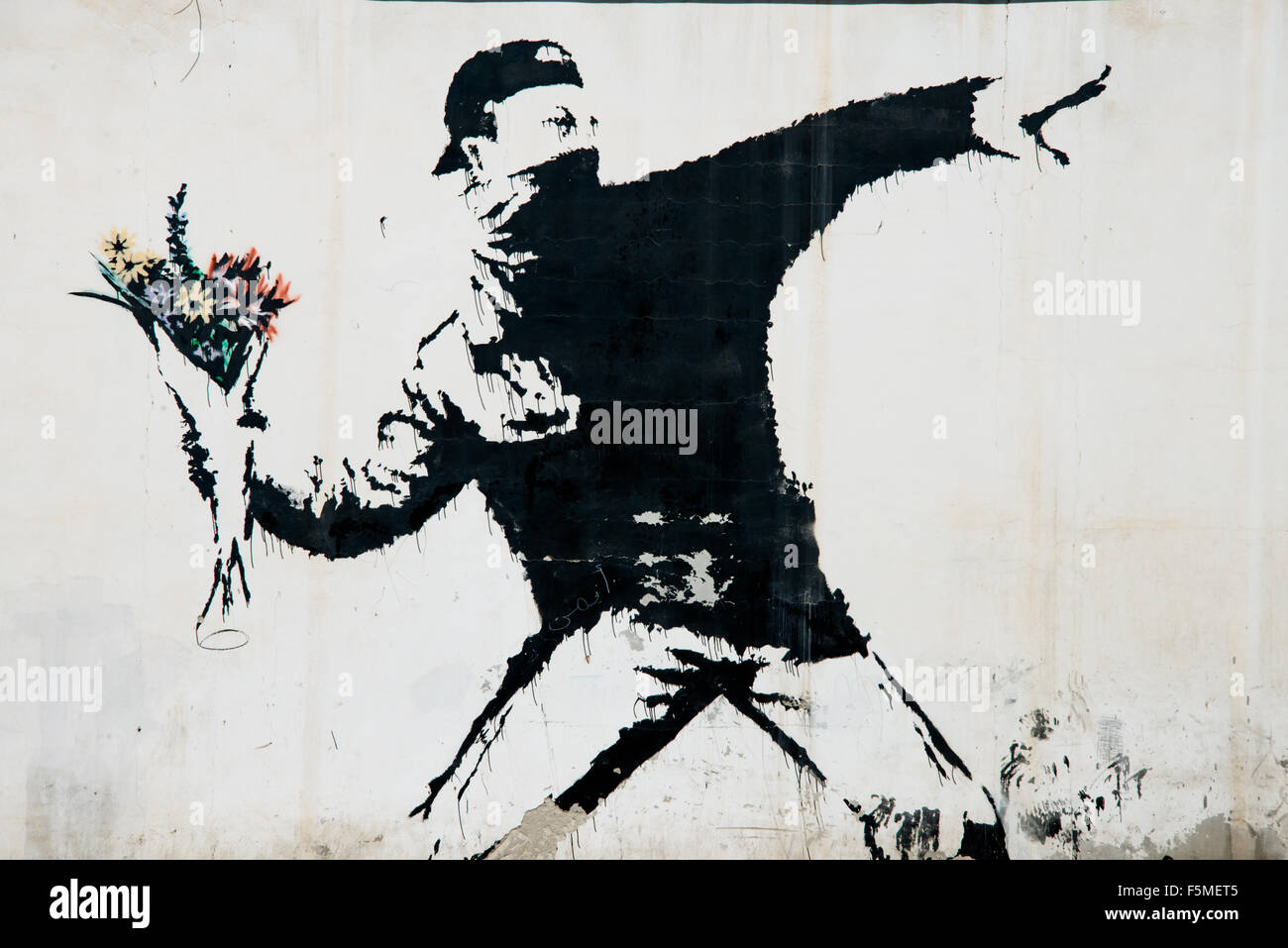A mural by the artist Banksy covers a wall in the Wests Bank village of Beit Sahour, June 18, 2014. Stock Photo