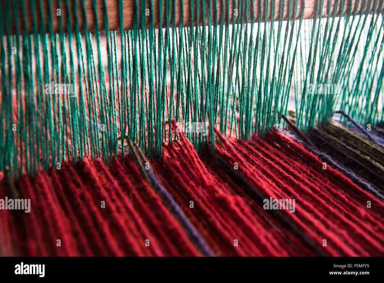 Wool yarn on a loom at Lakiya Negev Weaving, a women's craft cooperative in the Arab Bedouin township of Lakiya, Israel. Stock Photo
