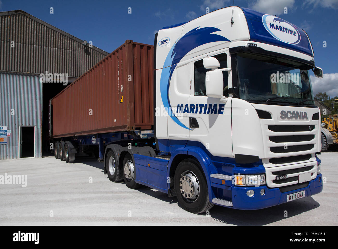 An articulated lorry with a 40 ft shipping container at a loading point Stock Photo