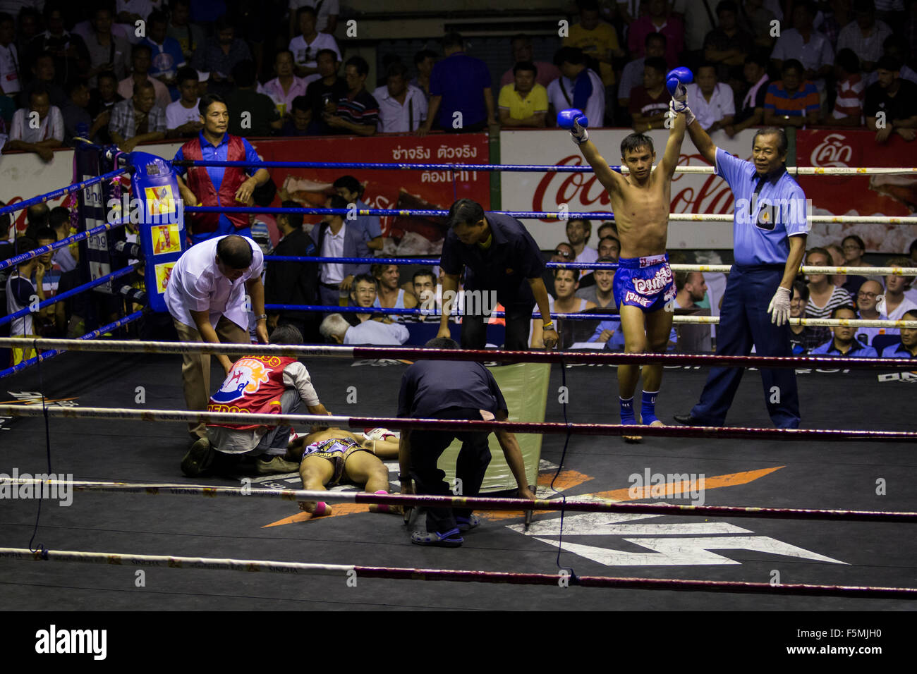 Knocked out fighter after a Muay Thai fight (Rajadamnern stadium, Bangkok, Thailand). Stock Photo