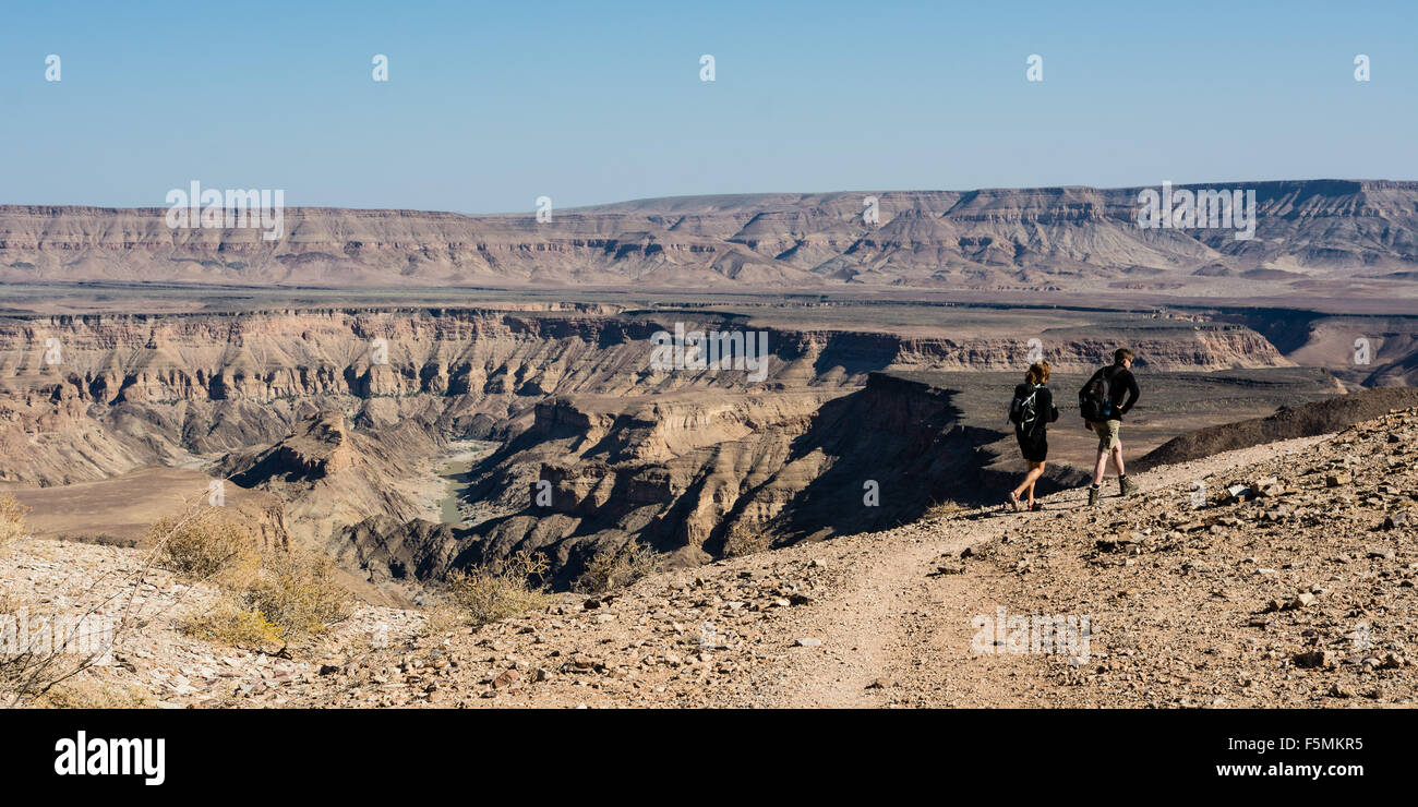 Namibia is a wonderful place for a hike or trek. This couple was hiking at the Fish River Canyon south in Namibia. Stock Photo