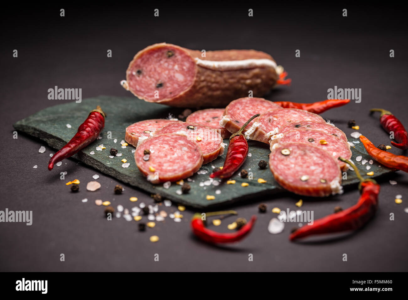 French salami on black slate background Stock Photo