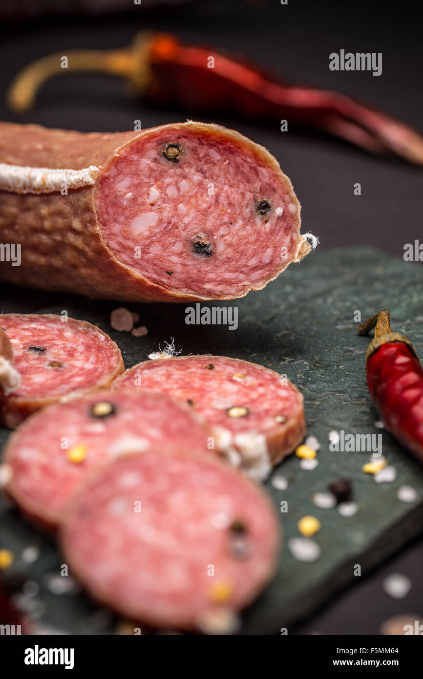 Italian salami with pepper on black Stock Photo Alamy