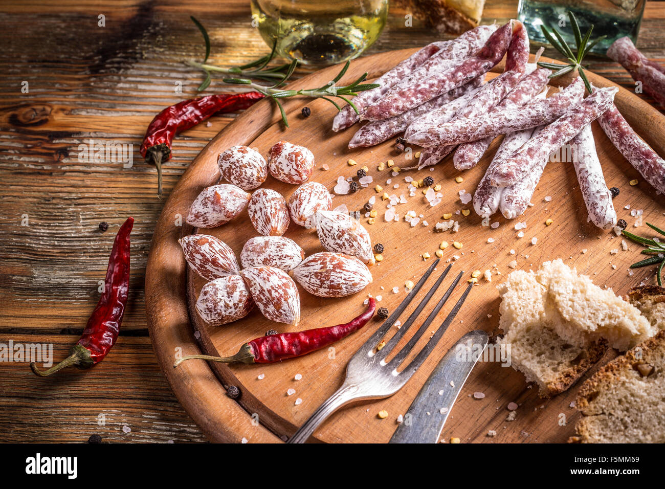Mini salami and salami sticks on wooden sutting board Stock Photo - Alamy