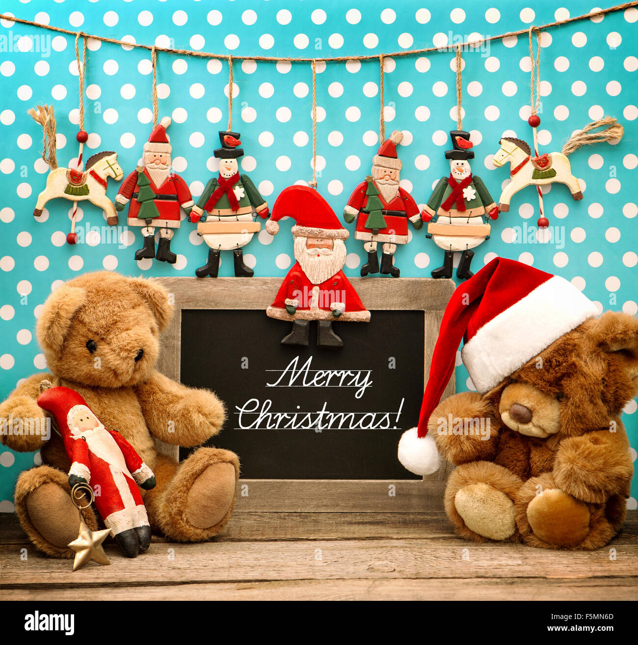Vintage christmas decoration with antique toys. Retro style toned picture.  Blackboard with sample text Merry Christmas Stock Photo