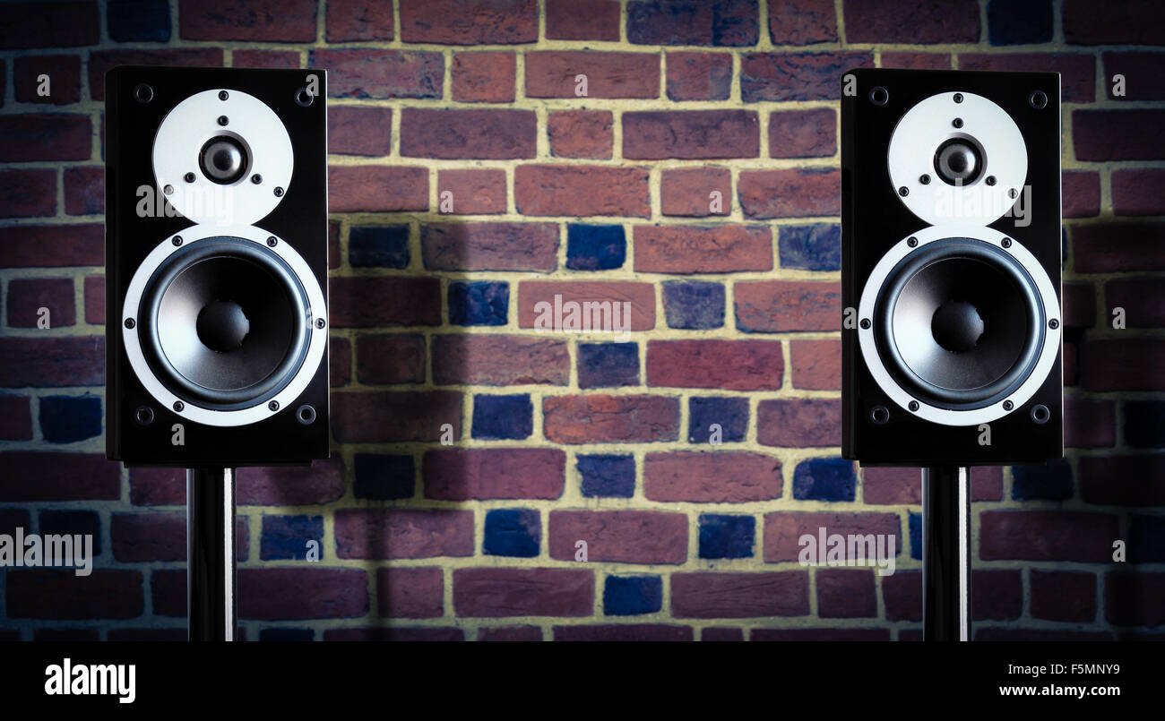 Black music speakers against brick wall background Stock Photo