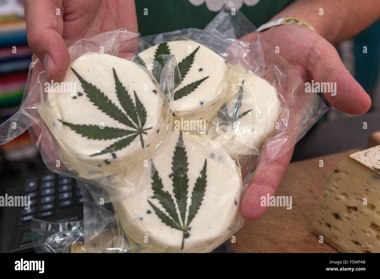 Sheep's cheese vacuum-packed, decorated with a cannabis leaf Prague Czech Republic Family farm product A man offers a product Stock Photo