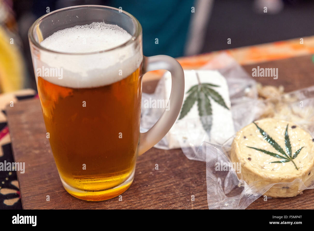 Vacuum packed sheep's cheese, decorated hemp leaf, Czech Republic beer, and cannabis edible Stock Photo