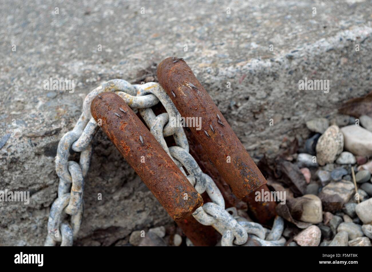 old rusted boat anchoring point in concrete with rusted metal hooks and ...