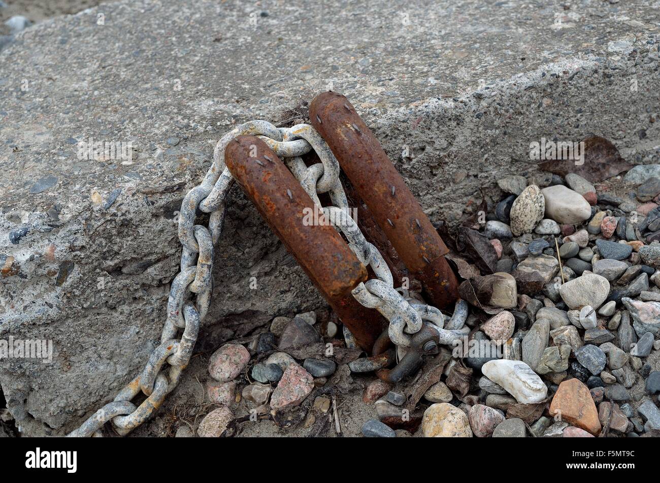 old rusted boat anchoring point in concrete with rusted metal hooks and ...