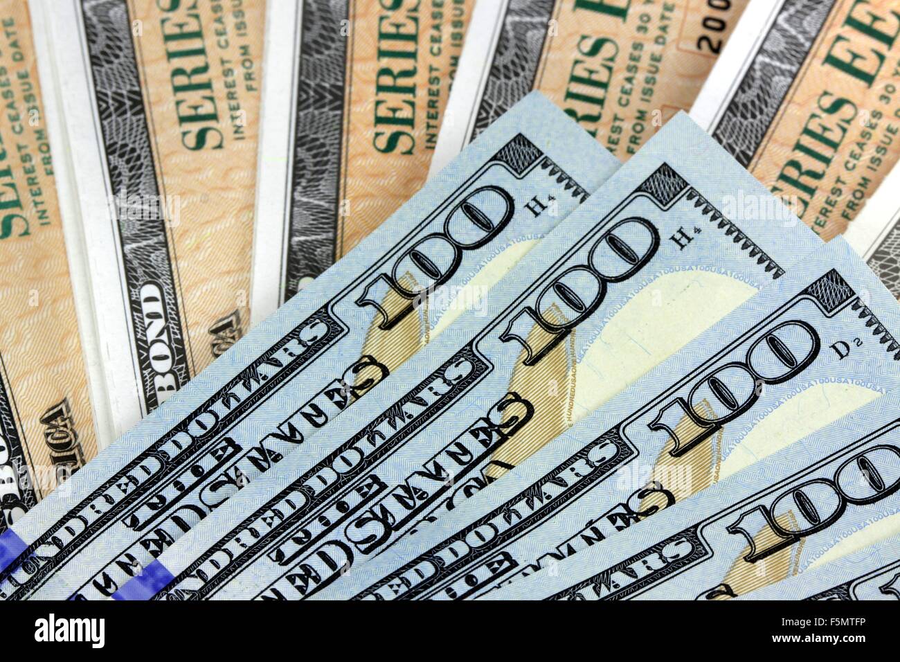 United States Savings Bonds with American Currency - Financial Security Stock Photo