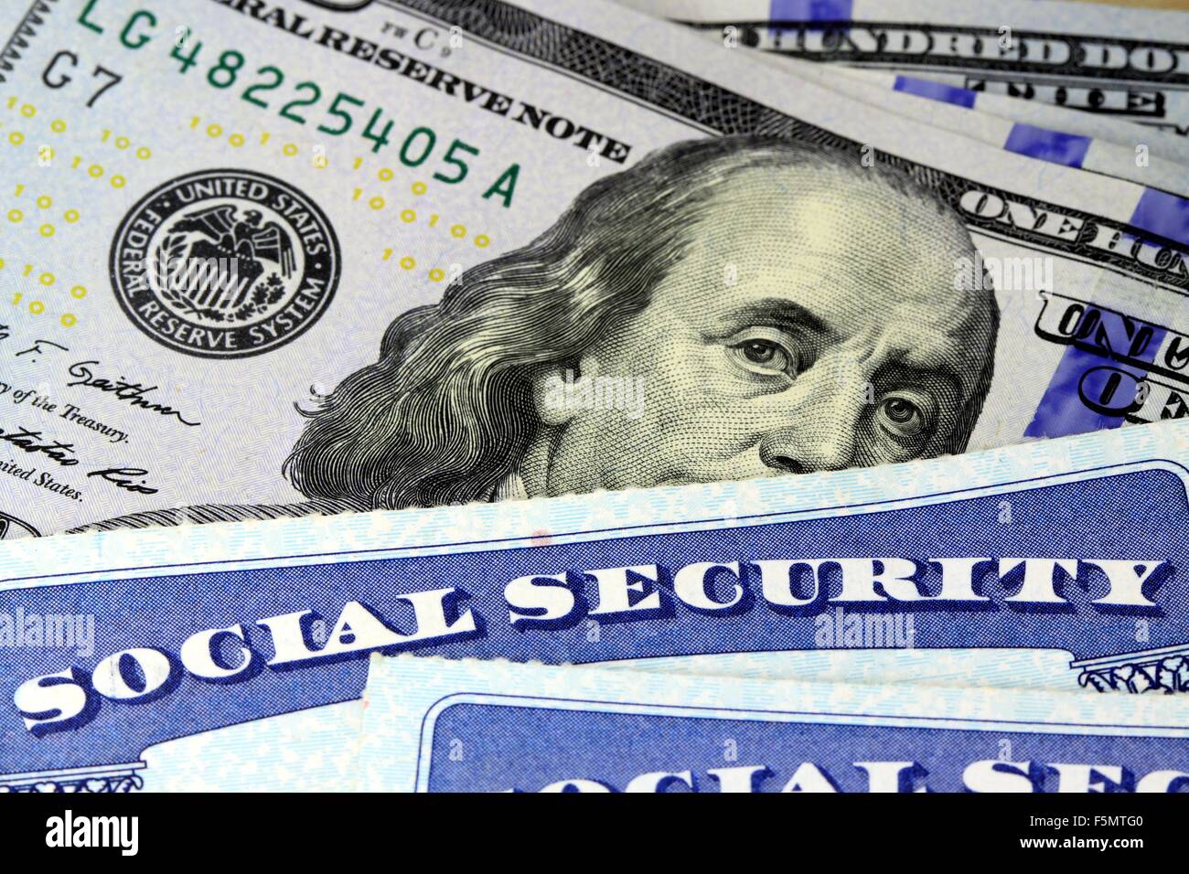 Social security card and US currency one hundred dollar bill Stock Photo