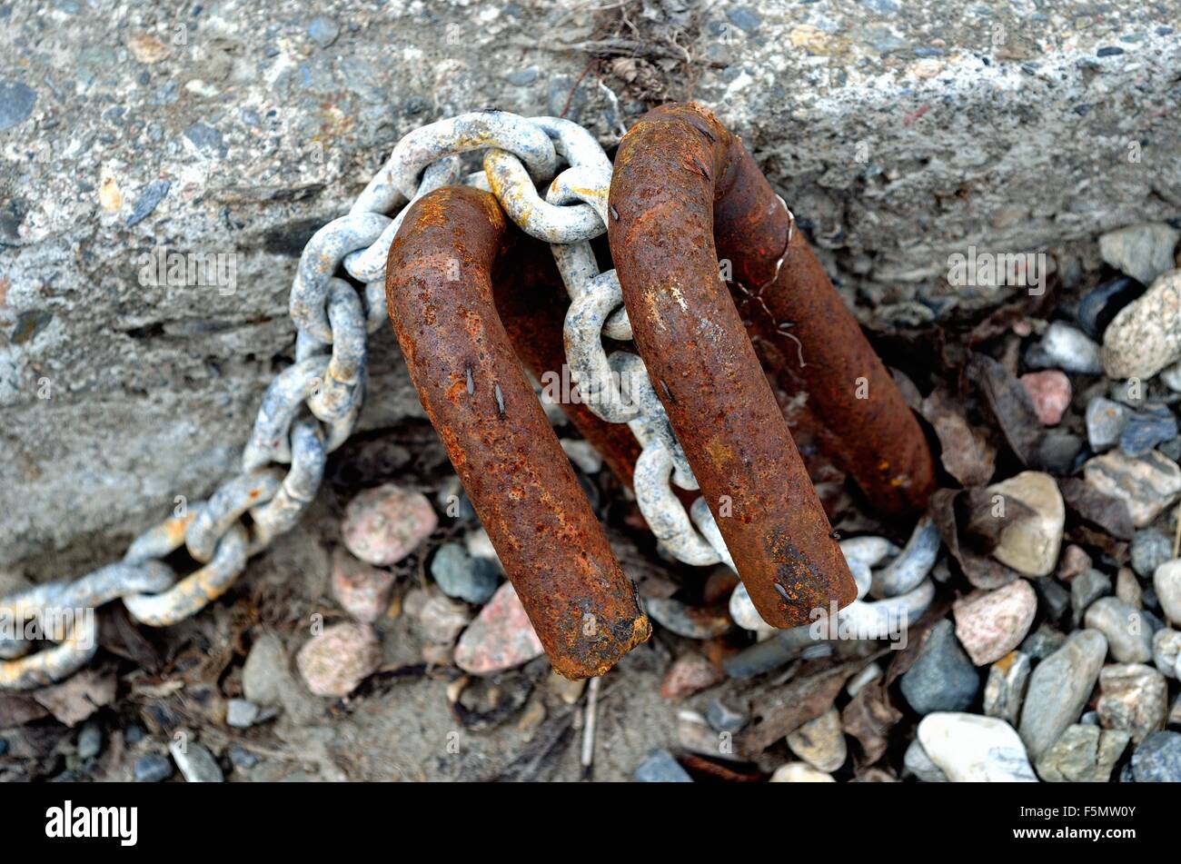 old rusted boat anchoring point in concrete with rusted metal hooks and ...