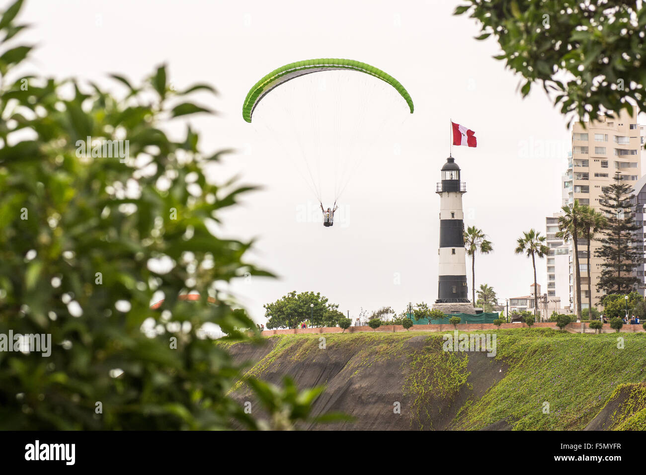 Paragliding around the La Marine Lighthouse in the Larcomar / Miraflores area of Lima city in Peru Stock Photo