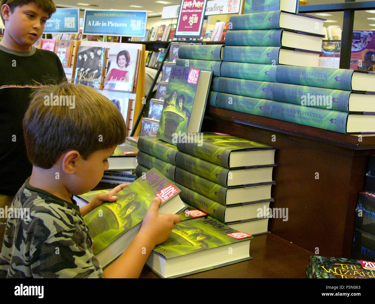 Jul 16, 2005; Aliso Viejo, CA, USA; JK Rowling the writer from Scotland releases her latest book 'Harry Potter and the Half-Blood Prince'. A young shopper grabs his copy in Barnes and Noble bookstore, Aliso Viejo, California. After being the fastest moving book in history in the UK market by selling at 24 copies a second, the latest book in the Harry Potter fantasy series, sold 6.9 million copies in its first day in the United States. Mandatory Credit: Photo by Ruaridh Stewart/ZUMA Press. (©) Copyright 2005 by Ruaridh Stewart Stock Photo