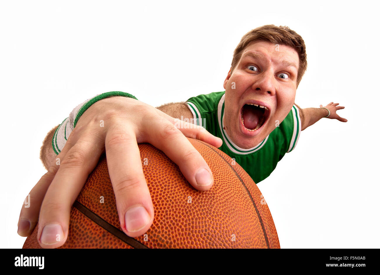 Portrait of bizarre basketball player shooting ball to basket. Isolated ...