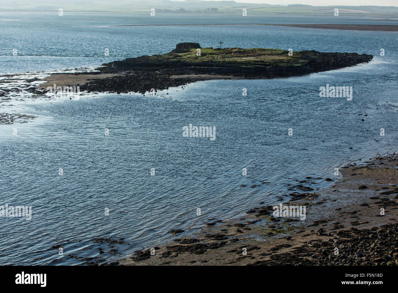 Saint Cuthbert island part of the Holy Island in Northumberland. View from the main island at high tide. Stock Photo