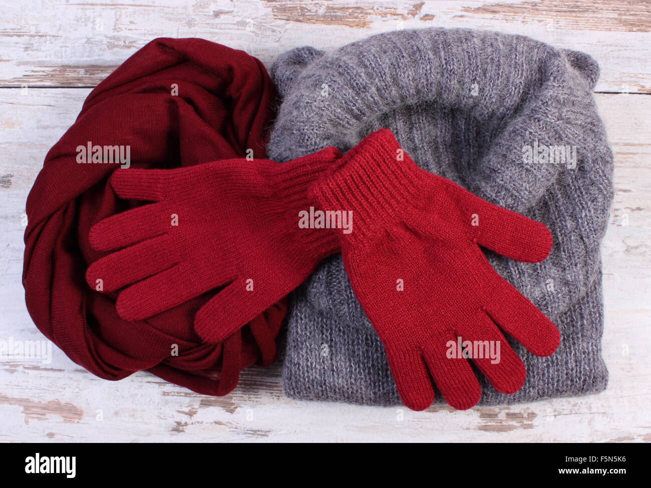 Woolen clothes for woman on old rustic wooden background, womanly