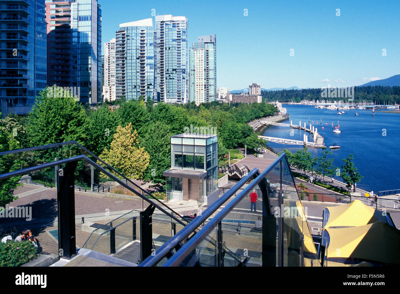 Vancouver, British Columbia, Canada - Skyline at Coal Harbour, Highrise Condominium Buildings & Harbour Green Park along Seawall Stock Photo