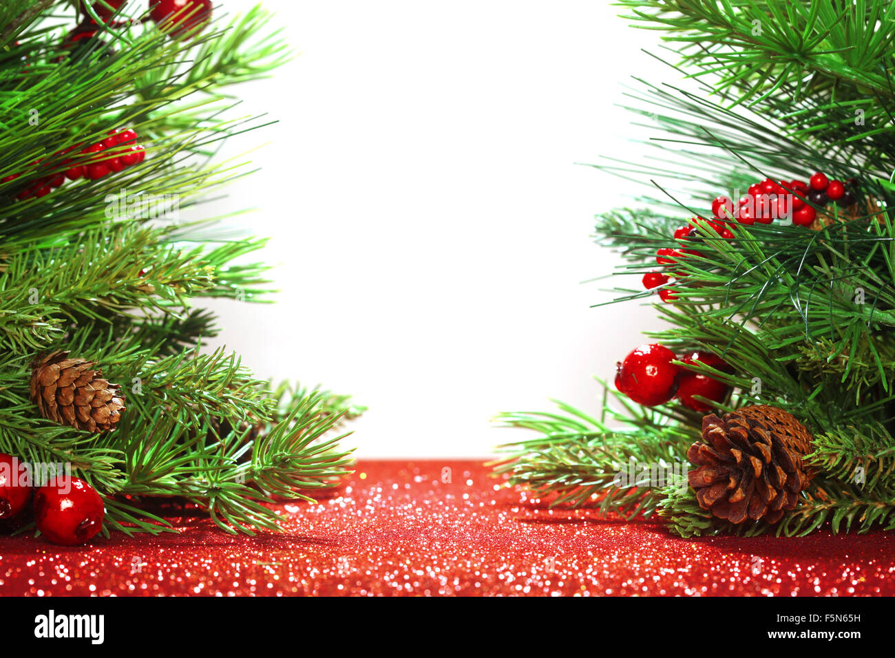 Christmas tree branches on glittering red background Stock Photo - Alamy