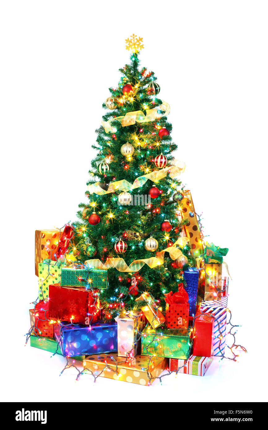 Decorated Christmas tree surrounded by colorful presents. Isolated on white. Stock Photo