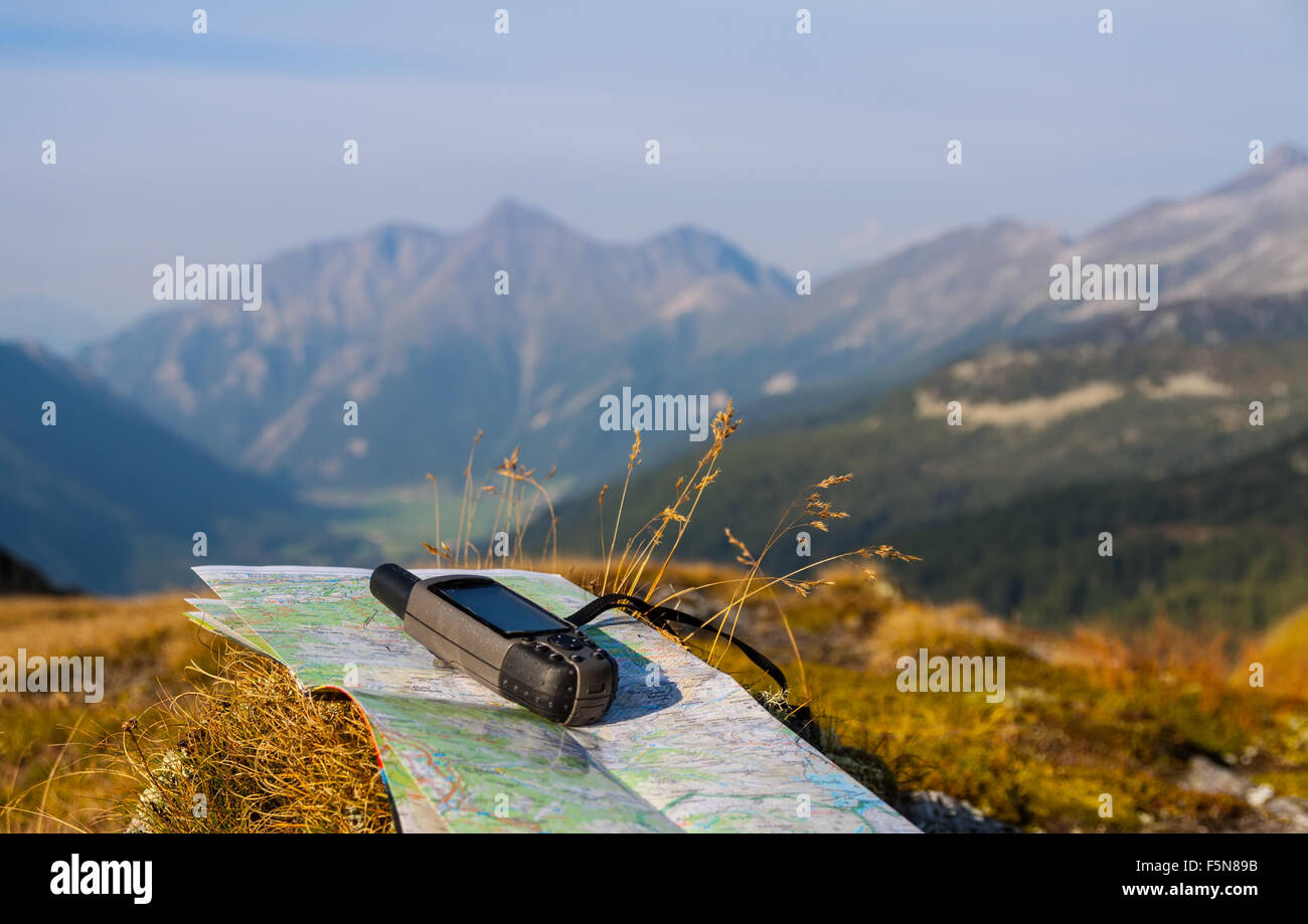 GPS navigator and map on Alps mountain background Stock Photo