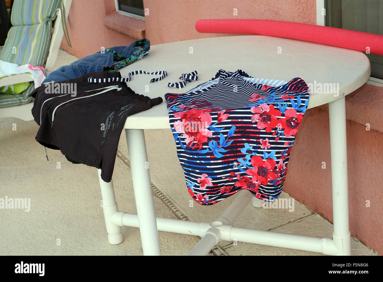 Swimsuits and clothes drying on the table outside a Florida vacation