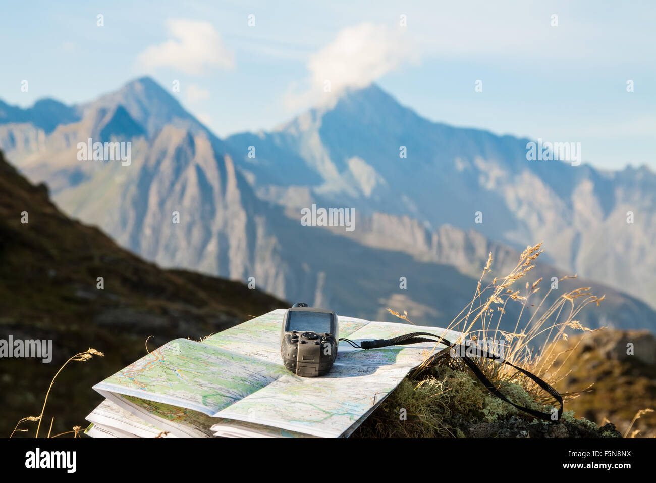 GPS navigator and map on Alps mountain background Stock Photo