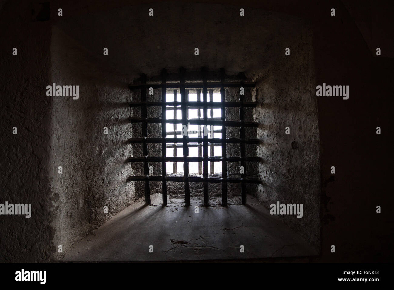 old prison window with steel grating in dark colors Stock Photo