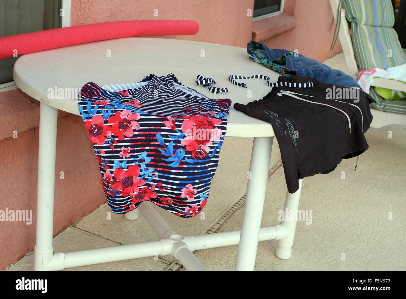 Swimsuits and clothes drying on the table outside a Florida vacation