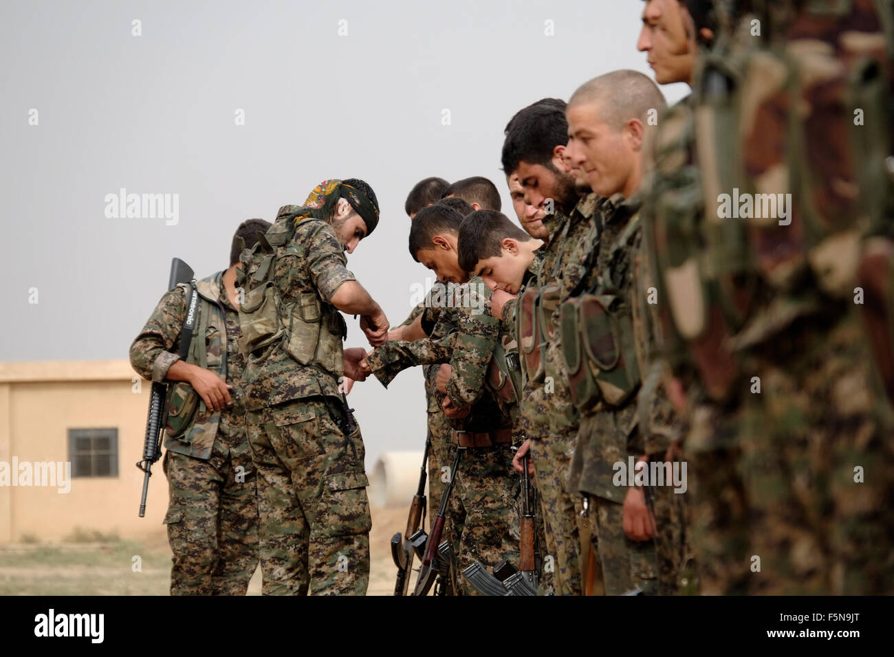 Kurdish fighters of the People's Protection Units YPG taking part in a recruitment ceremony in Al Hasakah or Hassakeh district in northern Syria Stock Photo