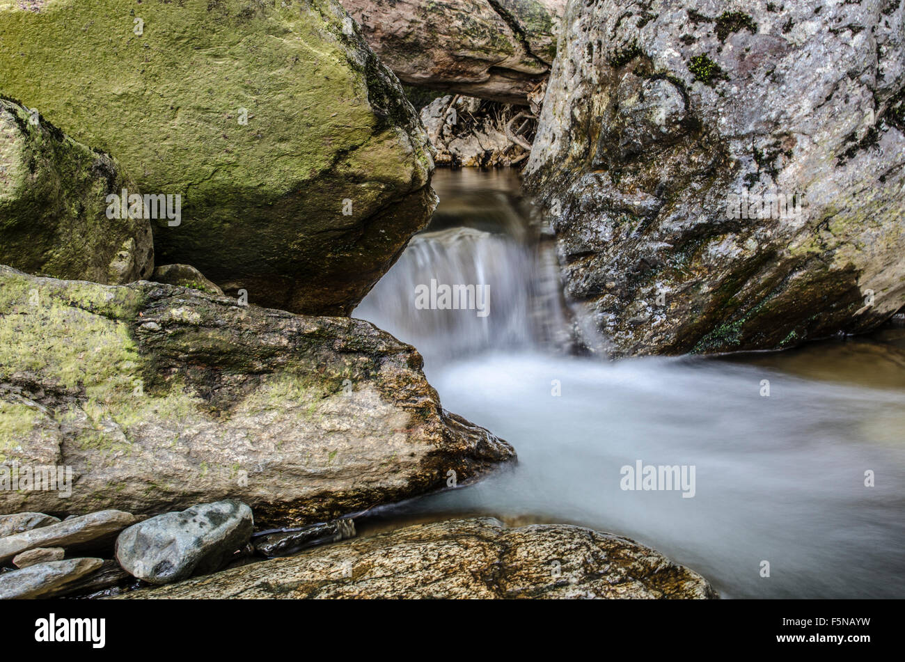 Lake district small waterfalls within the rocks, long exposures for misty water Stock Photo