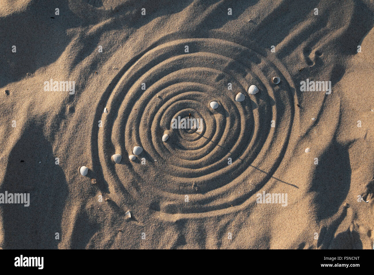 Conceptual sundial on the beach sand, as background Stock Photo