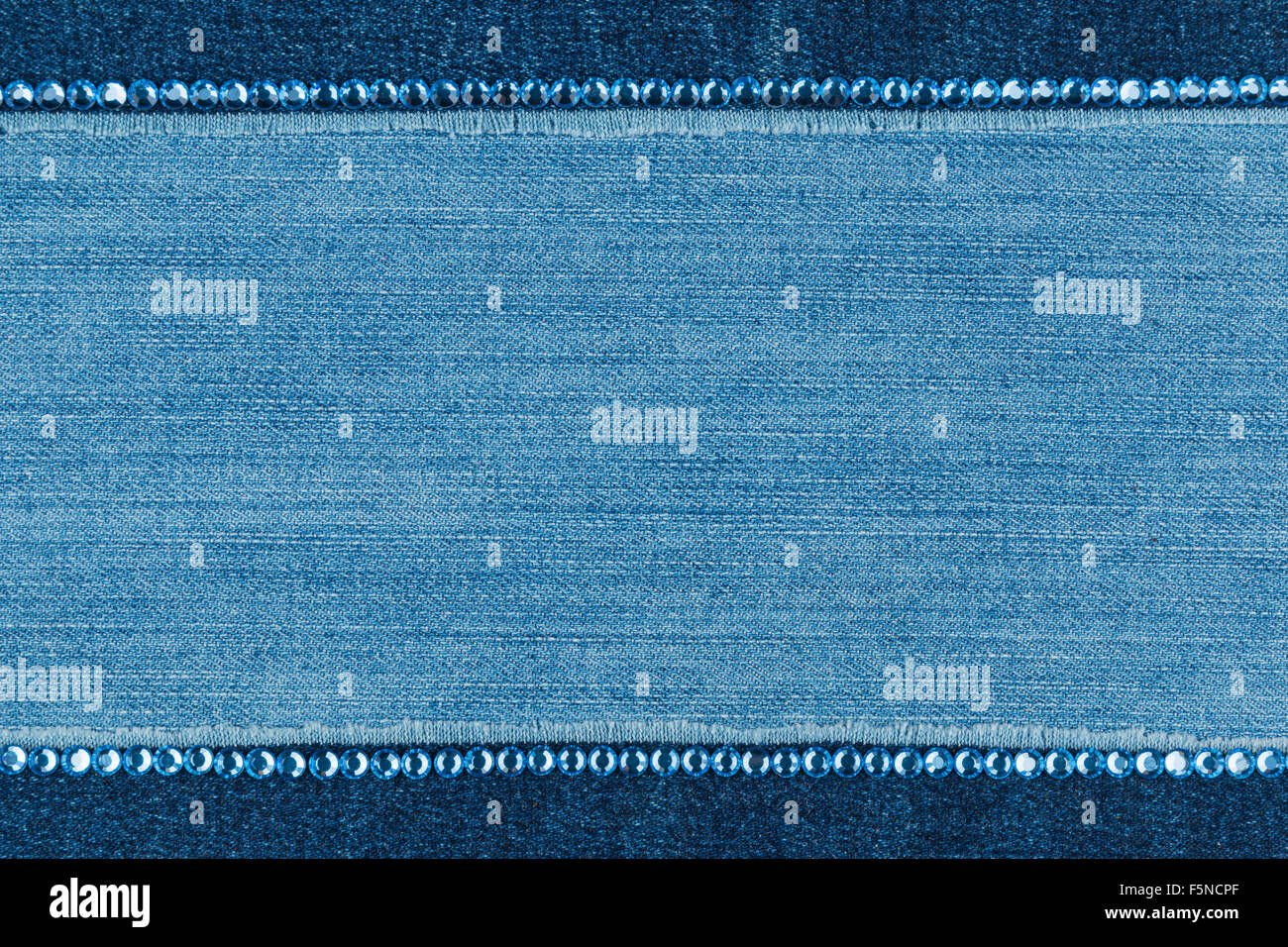 Fashionable  texture,  jeans and blue  rhinestones, with space for your text Stock Photo