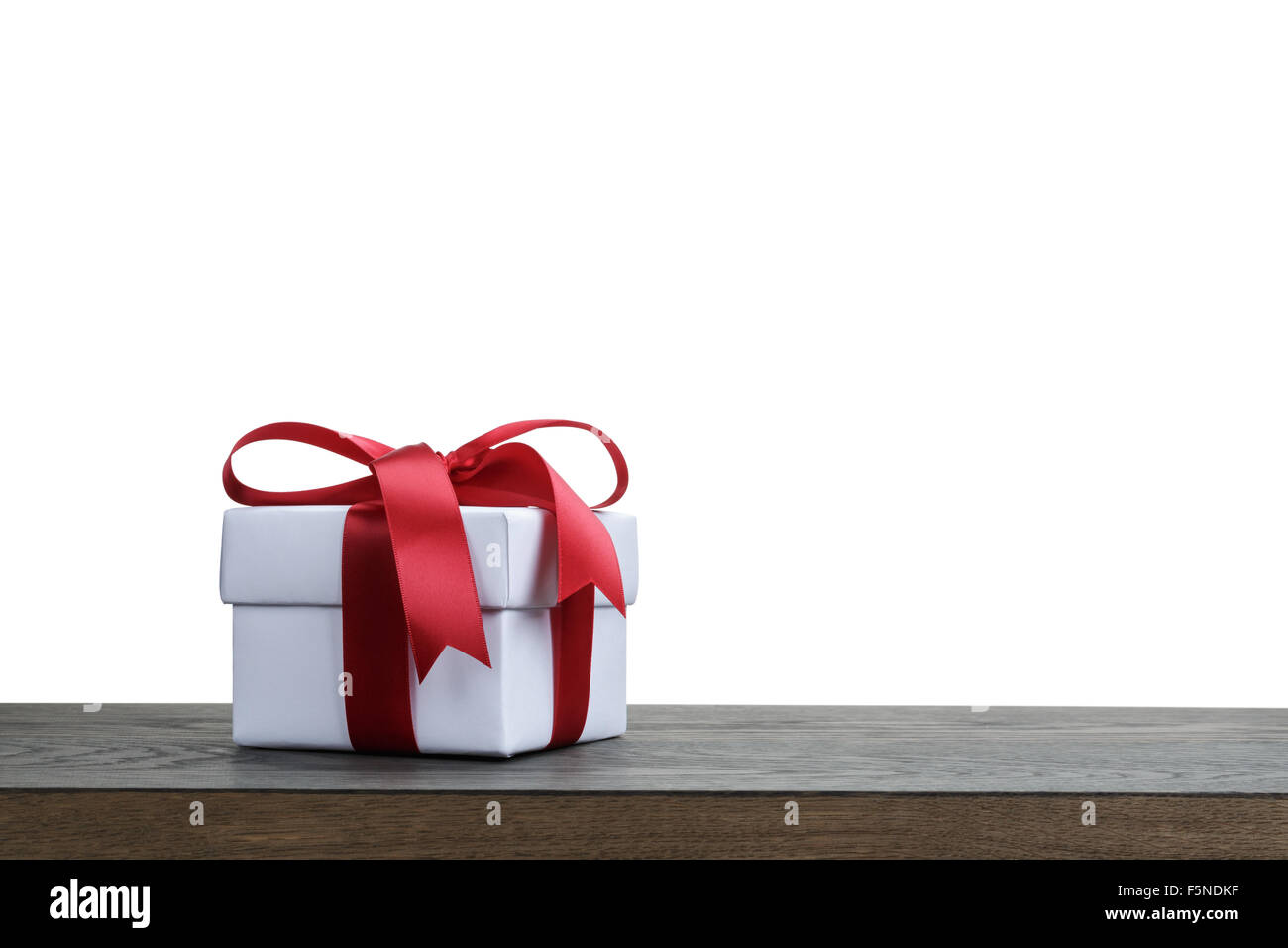 gift box with red bow on rustic table for border Stock Photo