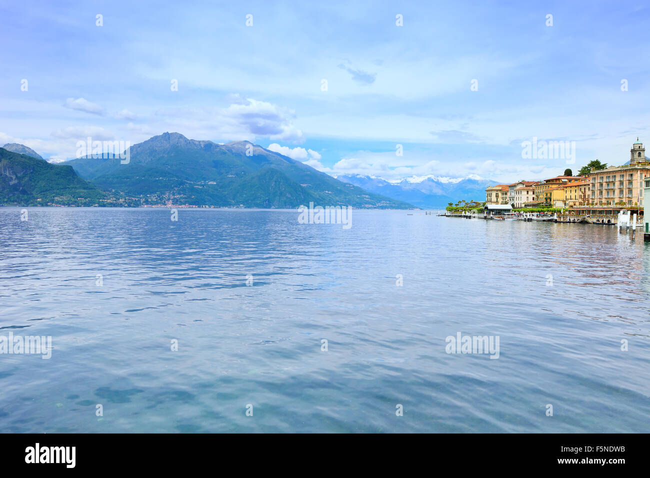 Bellagio town in Como lake district. Landscape with marina and italian traditional lake village. On background Alps mountains Stock Photo