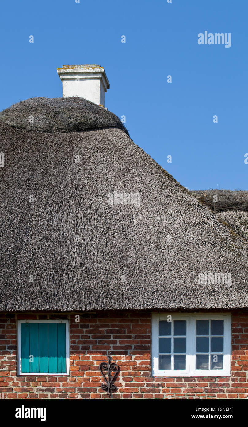 Detail of the roof of a beautifully maintained old farm house. The thatch is pristine clean and clearly looked after. Stock Photo