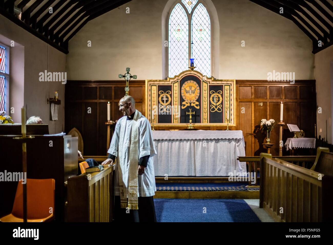 Getting ready for a religious service involving a christening Stock