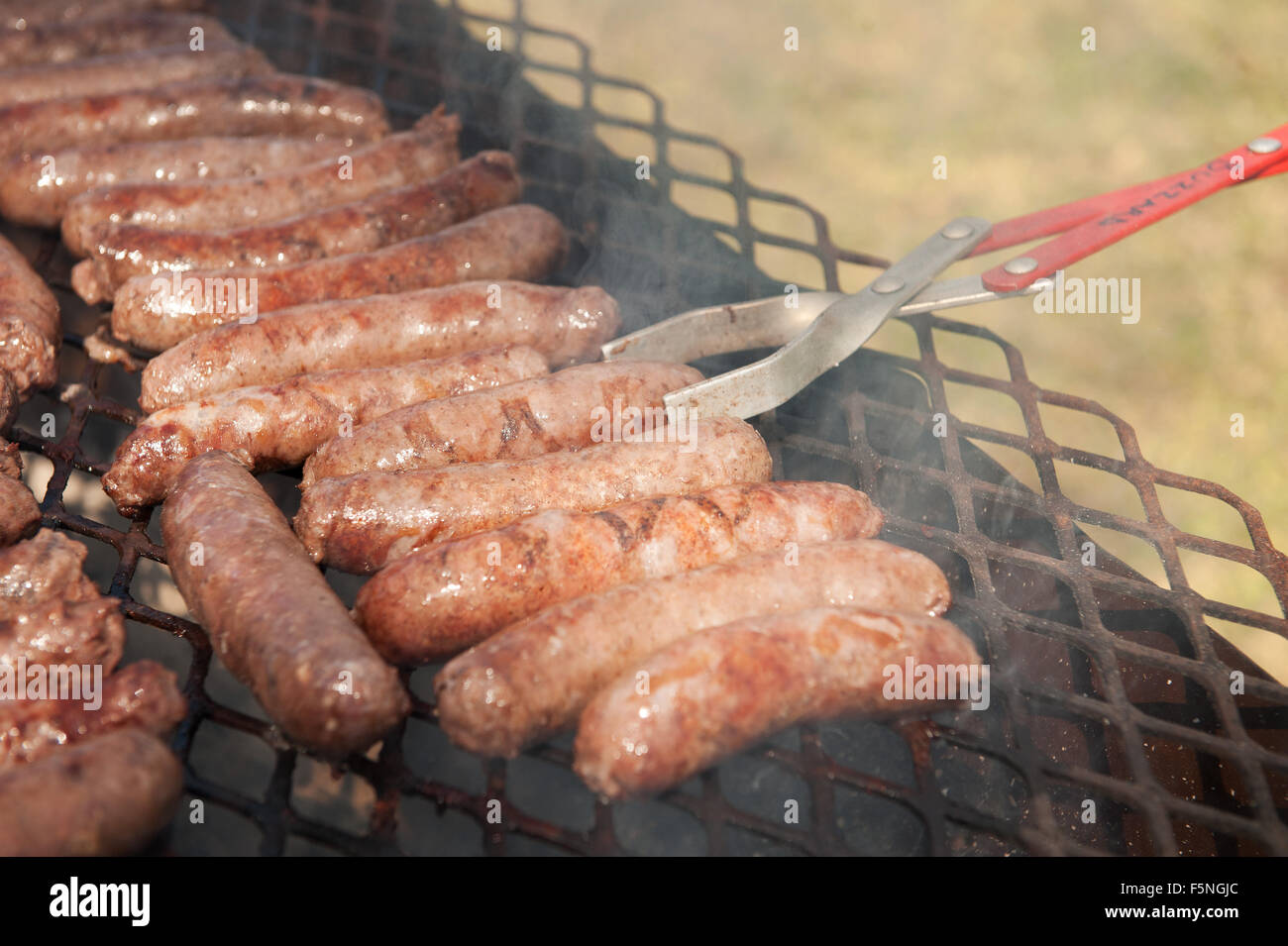 Traditional South African boervors sausages on a barbecue grill, or South African braai.  Creational South African meat sausage, know as Boerwors Stock Photo