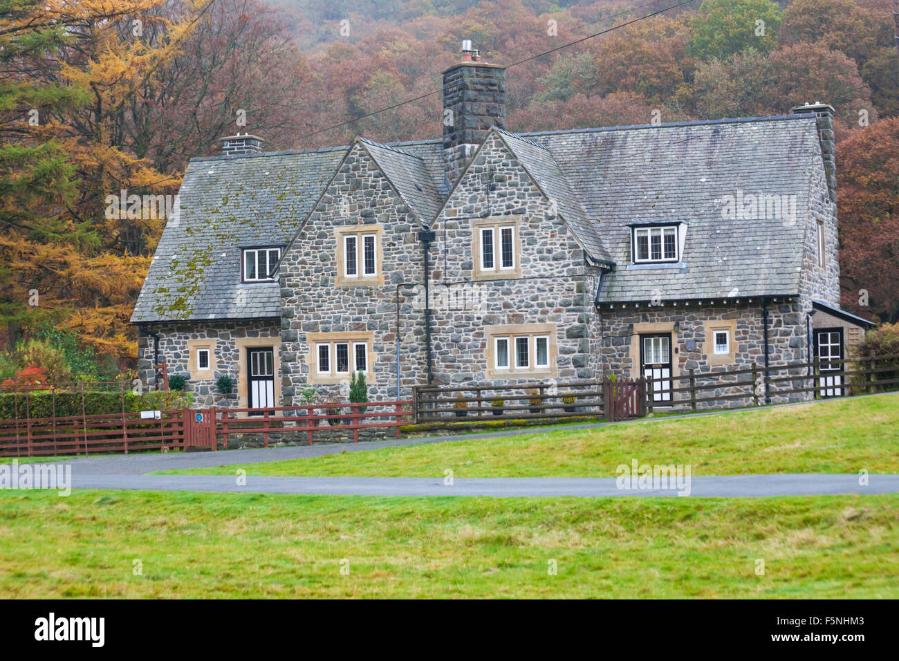 Houses in Autumn colours at Elan village in Elan Valley, Powys, Mid Wales, UK in November Stock Photo