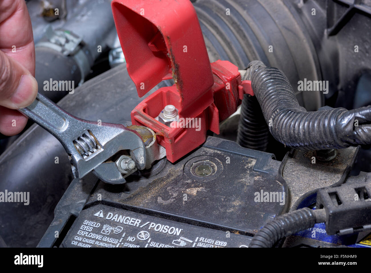 Mechanic tightens a nut on a battery terminal Stock Photo Alamy