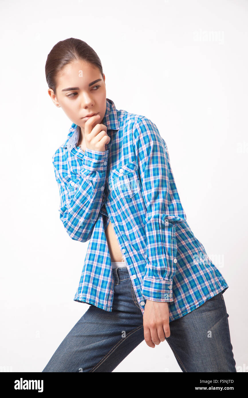 Attractive young woman in a blue shirt and jeans Stock Photo - Alamy