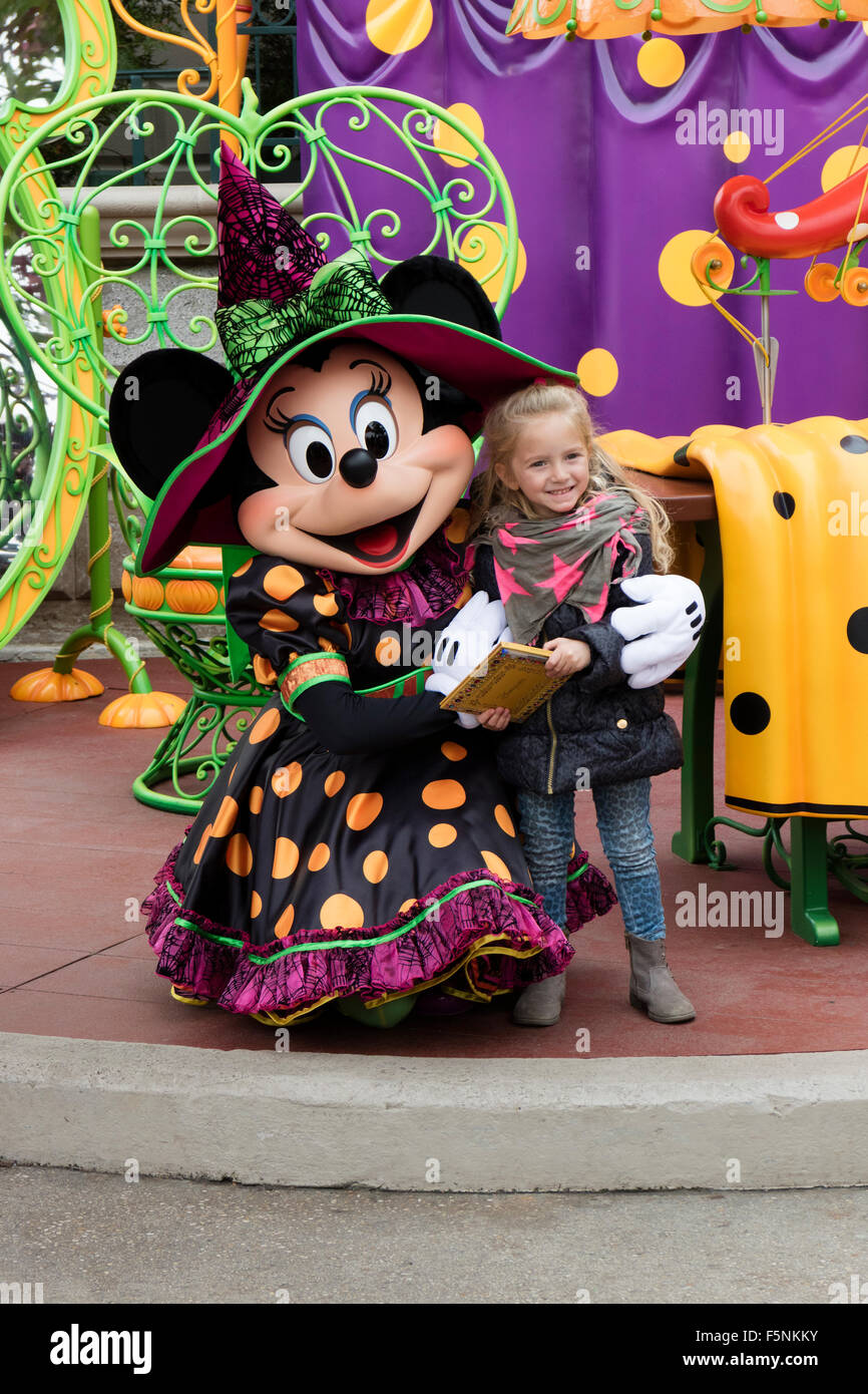 Child with Minnie Mouse in Disneyland Paris theme park, Marne-la-Vallée, Île-de-France, France Stock Photo
