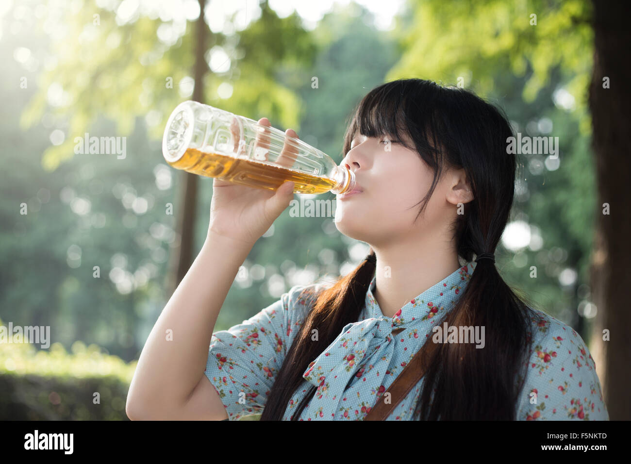 https://c8.alamy.com/comp/F5NKTD/asian-girl-drinking-beverage-F5NKTD.jpg