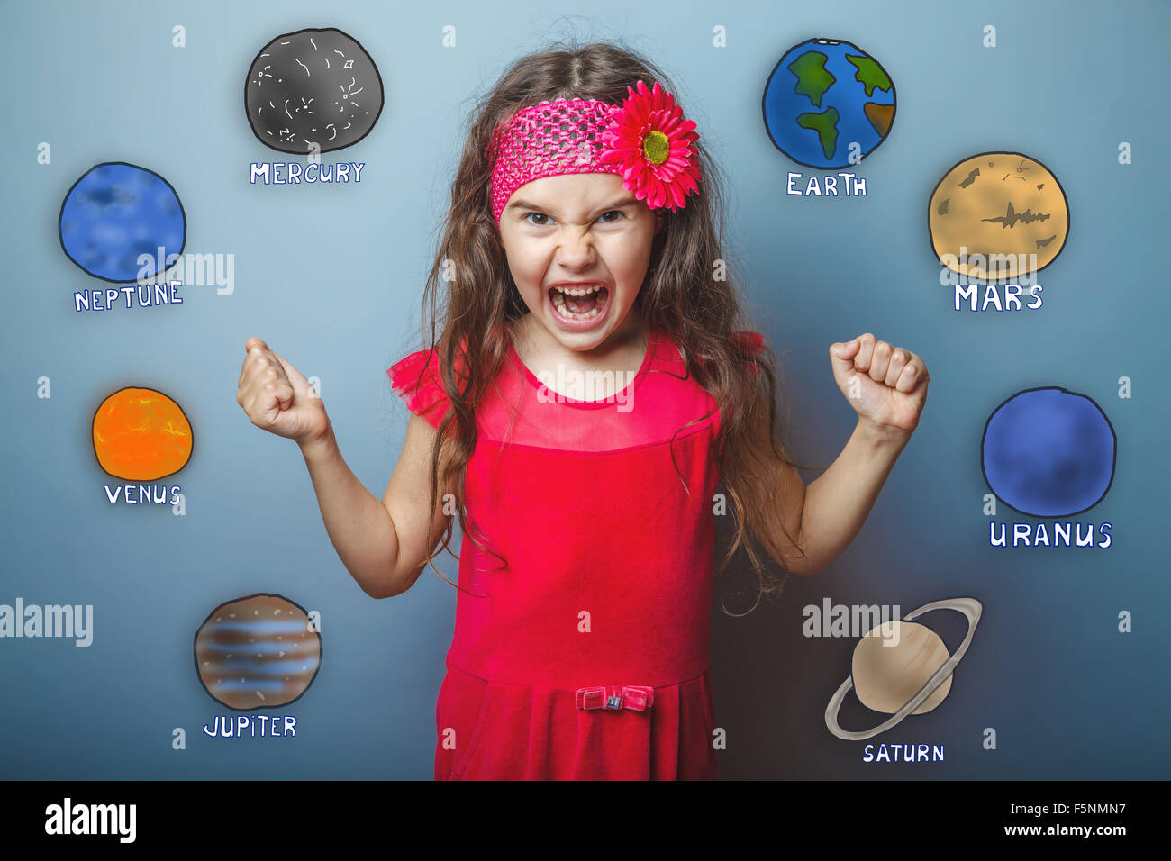 teen girl clenched her fists shouting angry planets of the solar Stock Photo